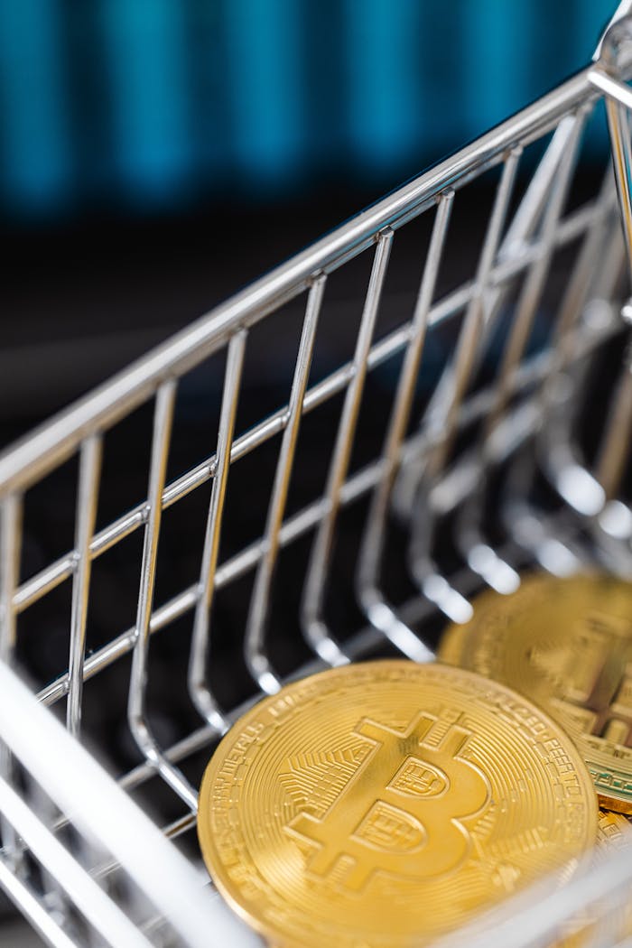 Photograph of Bitcoin coins inside a small shopping cart, symbolizing cryptocurrency investment.